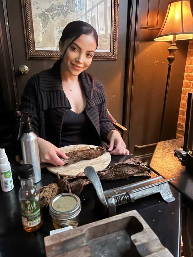 What are the benefits of having a live cigar rolling station at events?